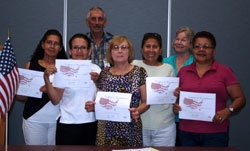 Jim Briggs and Kitty Adler, Literacy Tutors, celebrate with some of the learners 